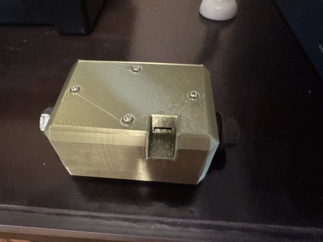 The rower telemetry prototype's closed 3D-printed enclosure: recessed lid screws, a side slot and a threaded boss.