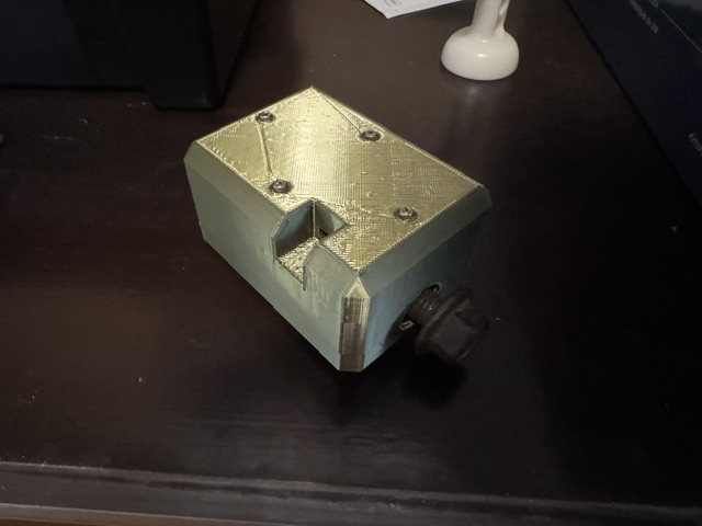 The prototype enclosure in a three-quarter view: the cut-out for the charging port and the black rotary knob on the printed housing.